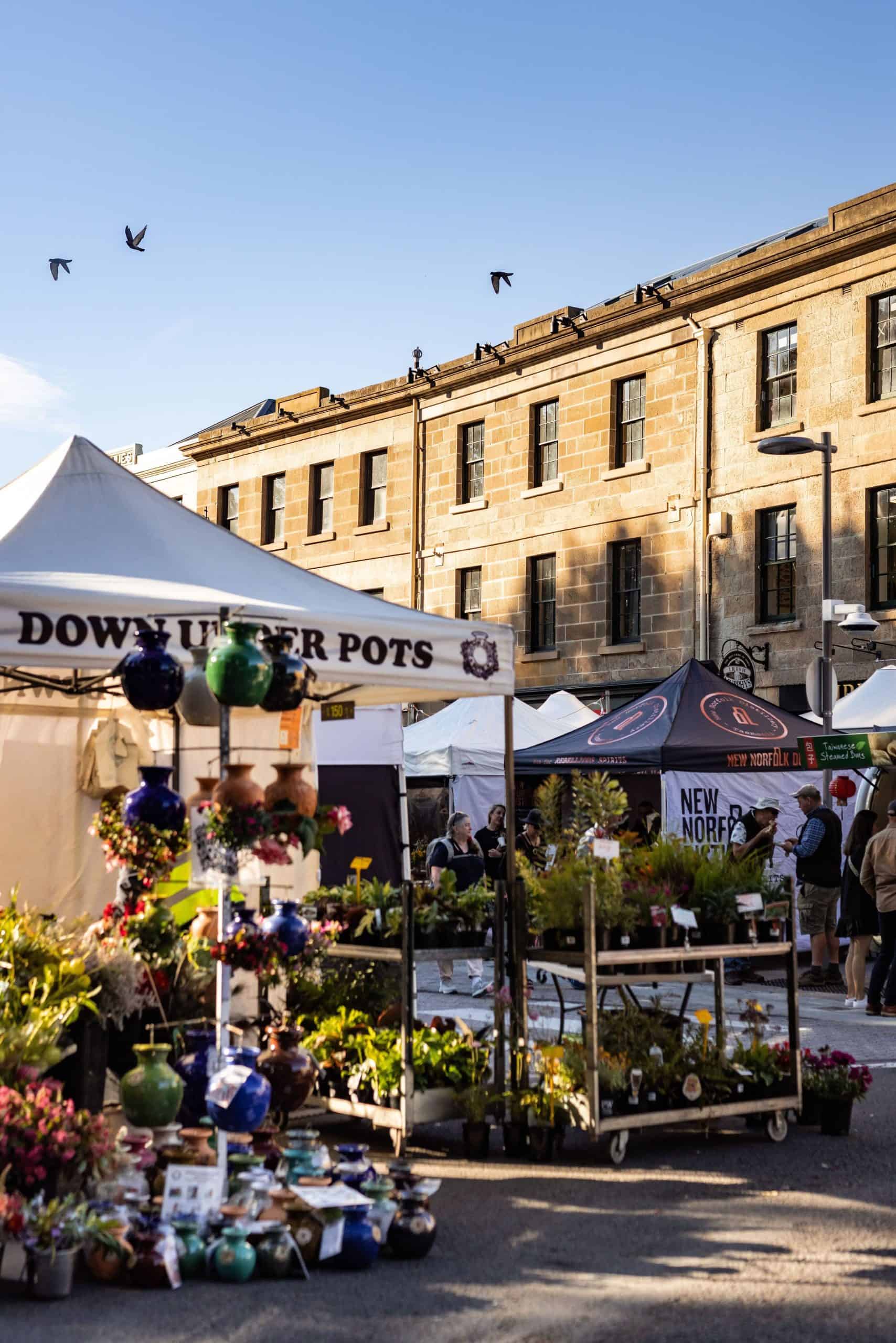 Set among the historic Georgian sandstone buildings of Salamanca Place in Hobart, people are exploring Salamanca Market