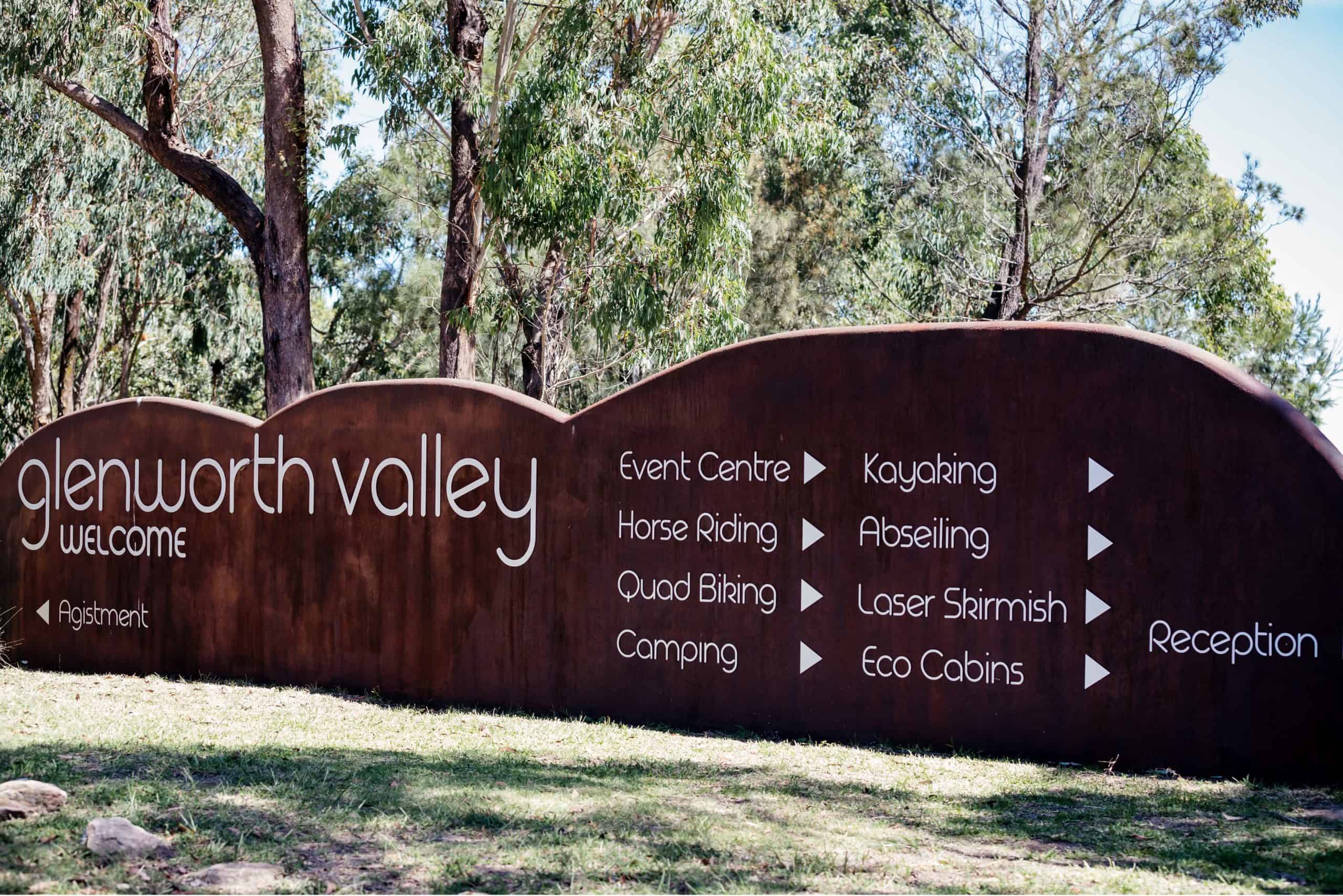 Glenworth Valley welcome board mentioning activities like horse riding, kayaking, abseiling, quad biking, laser skirmish, event centre, camping and eco cabins