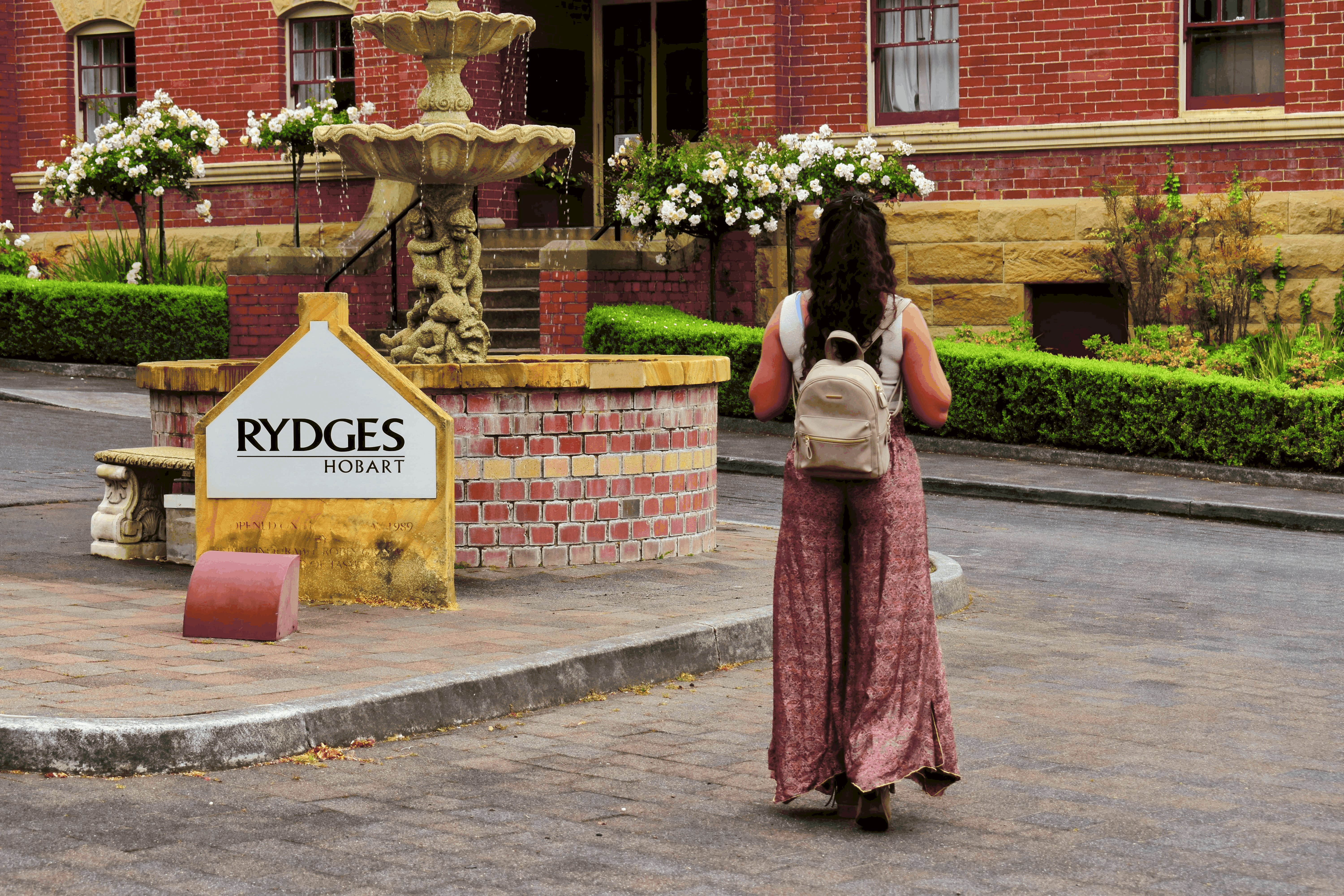 Girl walking besides tha fountain at  Rydges Hobart which is a affordable hotel for families in Hobart