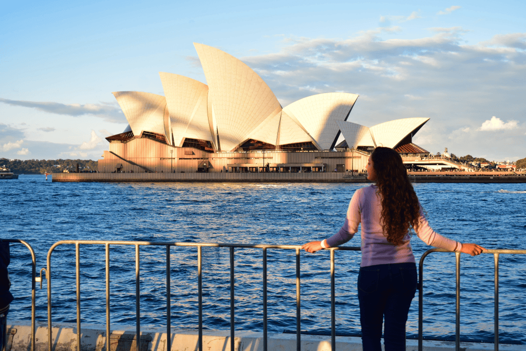 A girl posing in front of the harbour with stunning views of The Opera House!