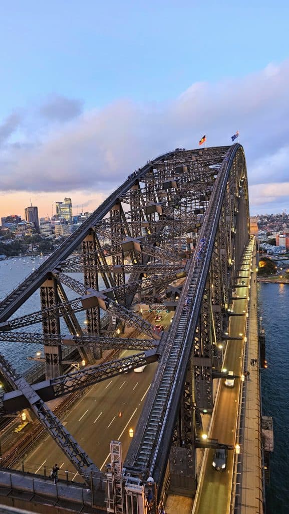 Sydney Harbour Bridge captured at dusk with climbers visible on the arch.