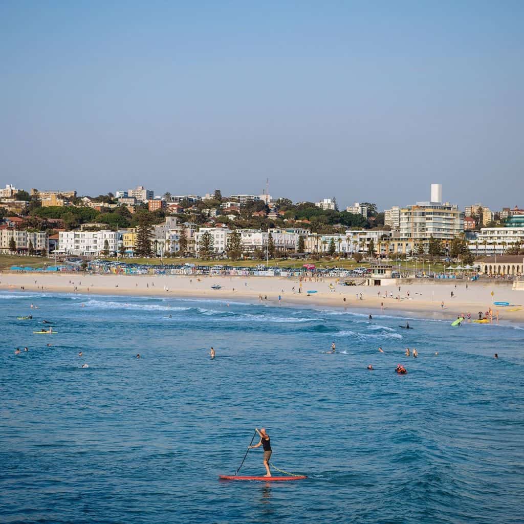 Bondi Beach with surfers and sunbathers – one of the most popular free things to do in Sydney.