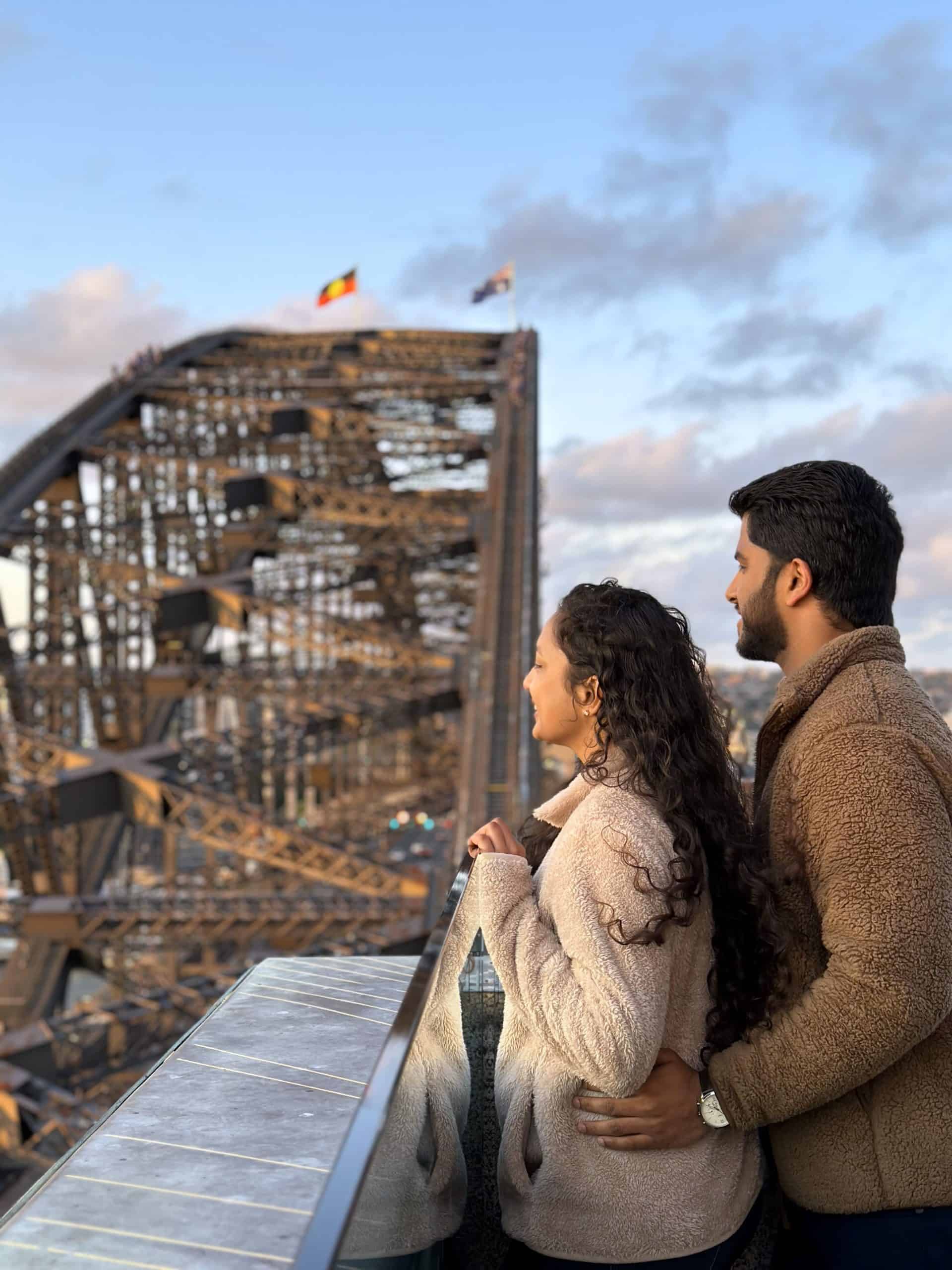 A couple looking over at the Harbour Bridge from the South pylon lookout.