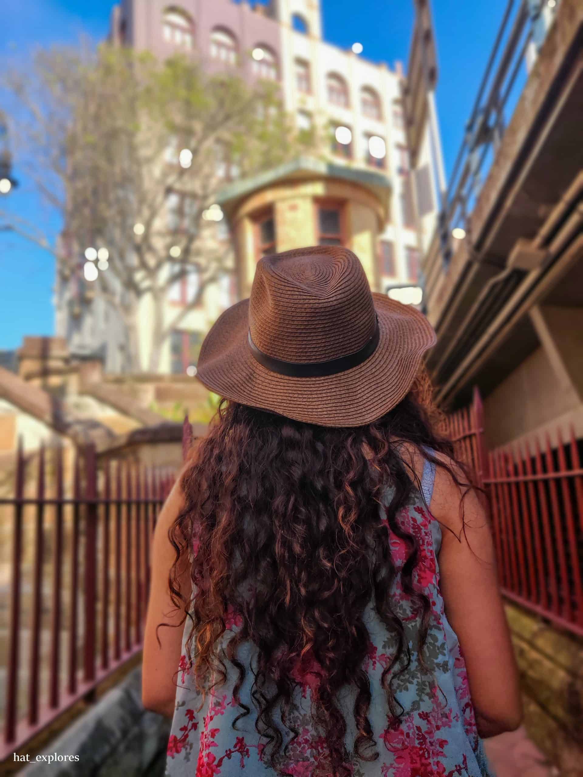 A girl looking over at Victorian architecture. 