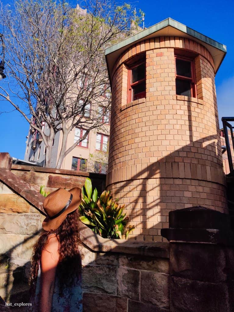 A girl looking over at heritage buildings in The Rocks.