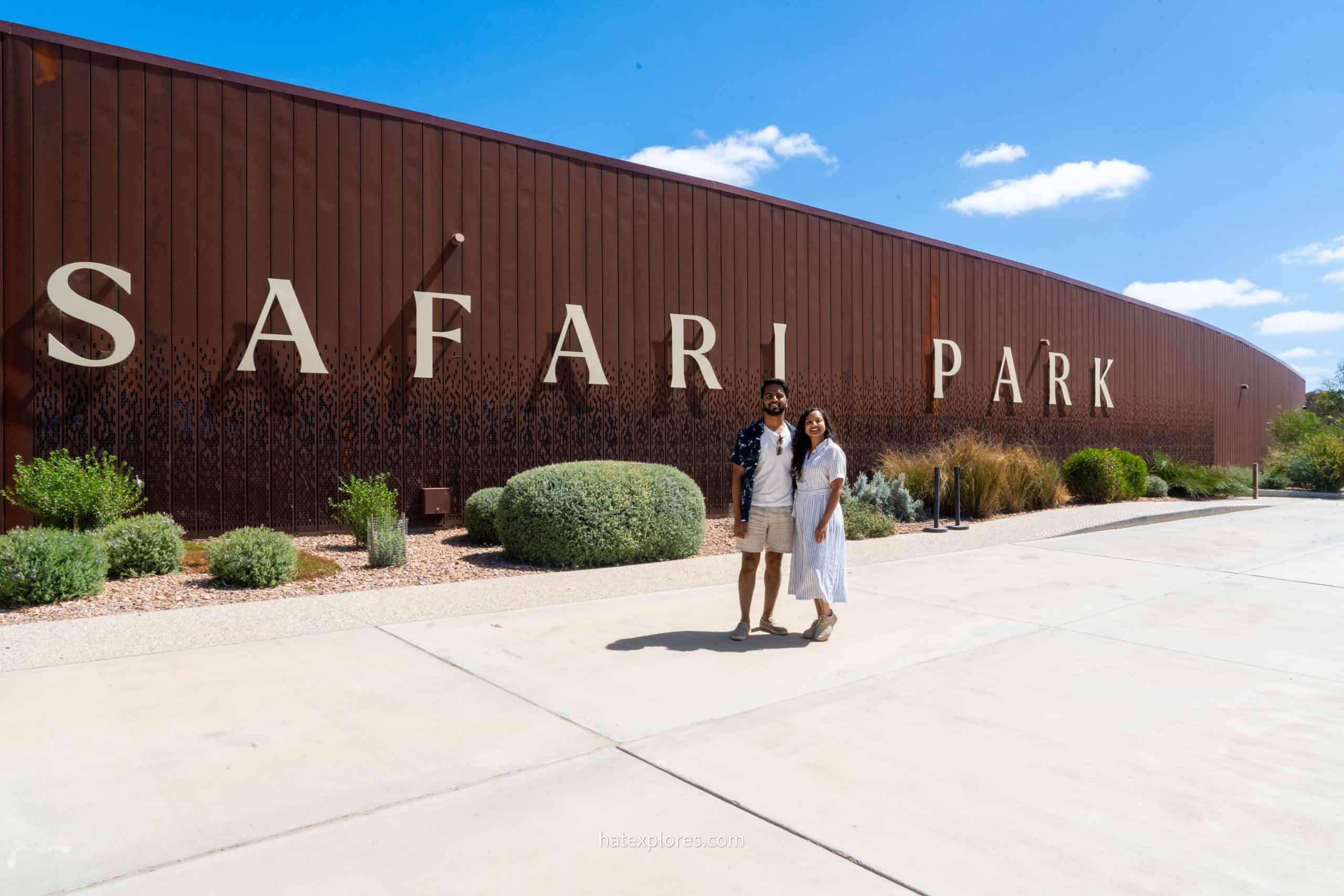 A couple posing while standing in front of the Safari Park gate following their 3-day Adelaide itinerary!