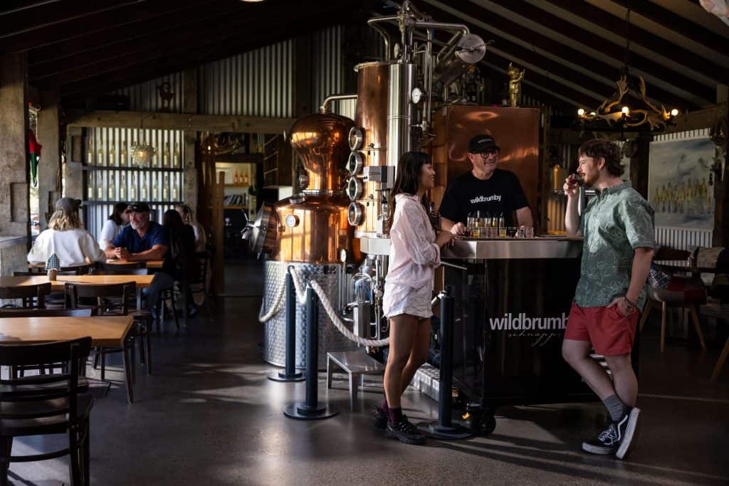 A couple enjoys schnapps tasting at Wildbrumby Schnapps Distillery , Snowy Mountains