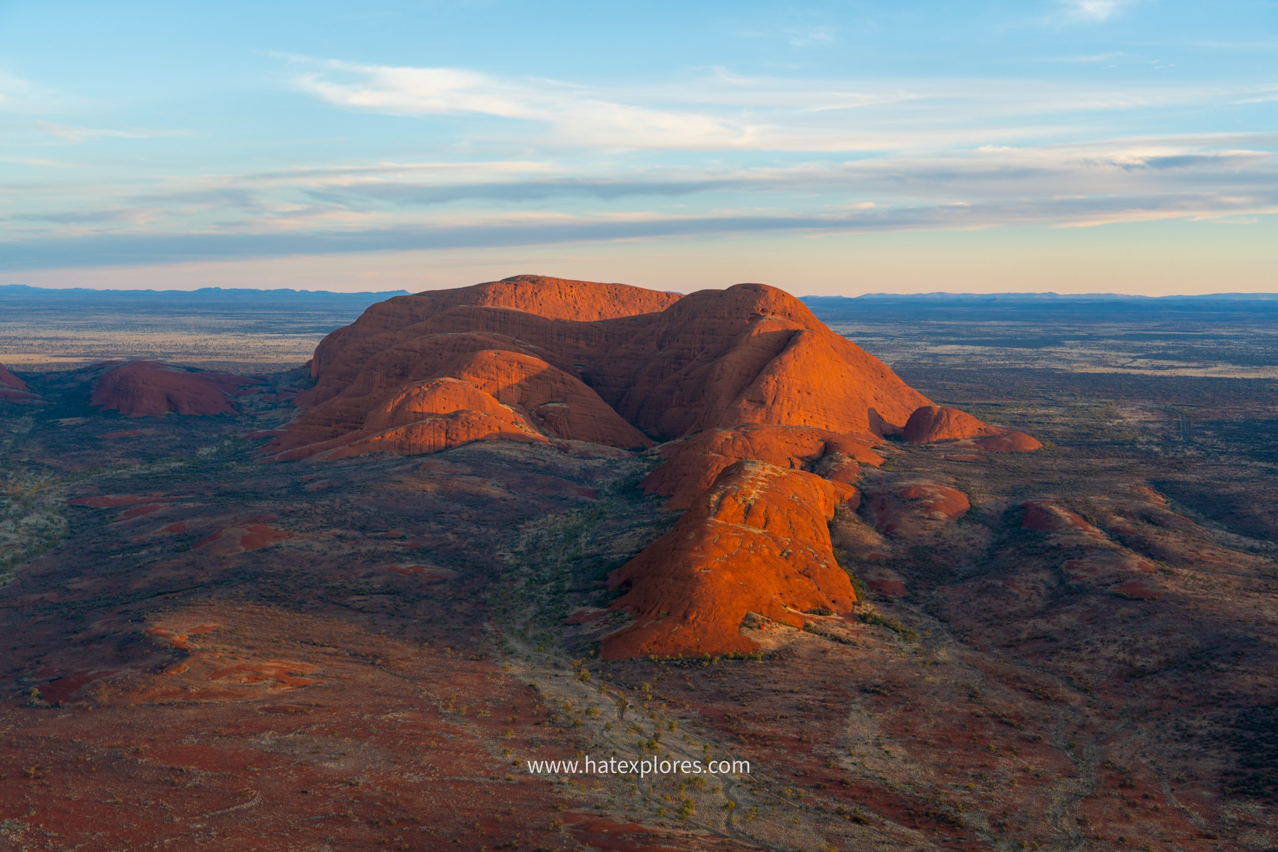Majestic domes of Kata Tjuta glowing in the sunset light, a must-see on the best Uluru tour itinerary in the Australian Outback.