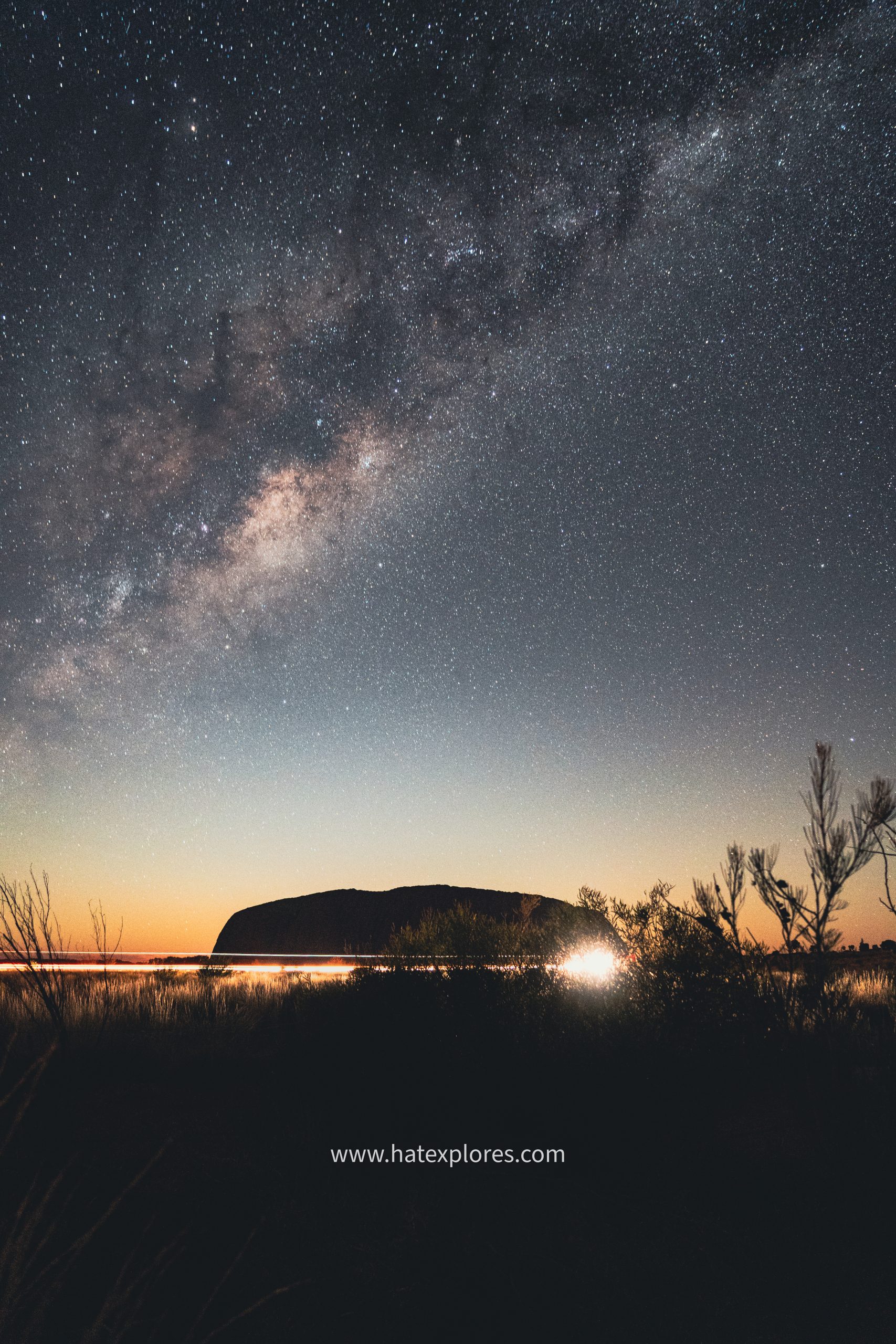 stargazing under a clear night sky with Uluru in the background.